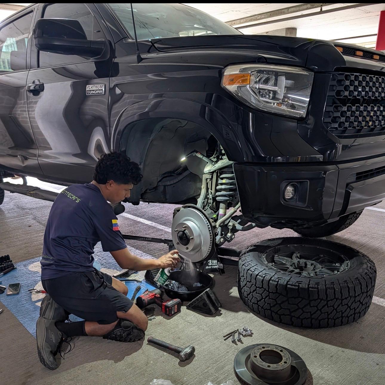 Manuel doing brake and suspension work on a truck